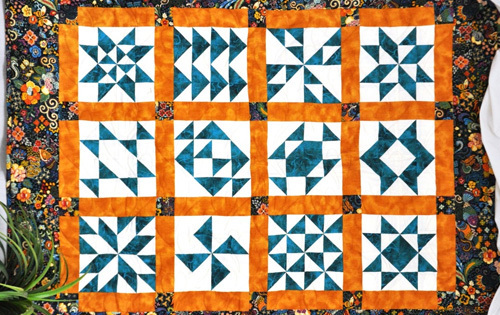 Hand Made Quilt with orange and blue squares